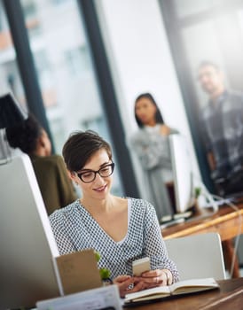 Technology allows her to reach her clients at any time. a young businesswoman texting on a cellphone in an office