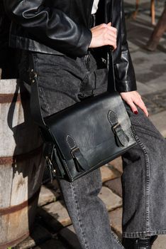 close-up photo of black leather bag corporate. street photo