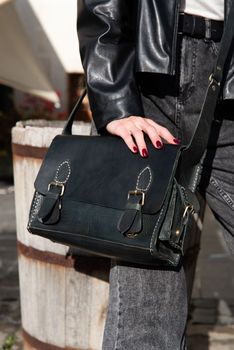 close-up photo of black leather bag corporate. street photo