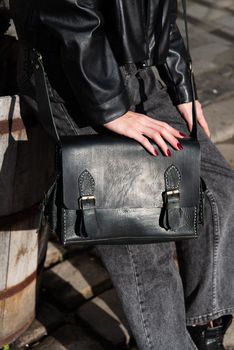 close-up photo of black leather bag corporate. street photo