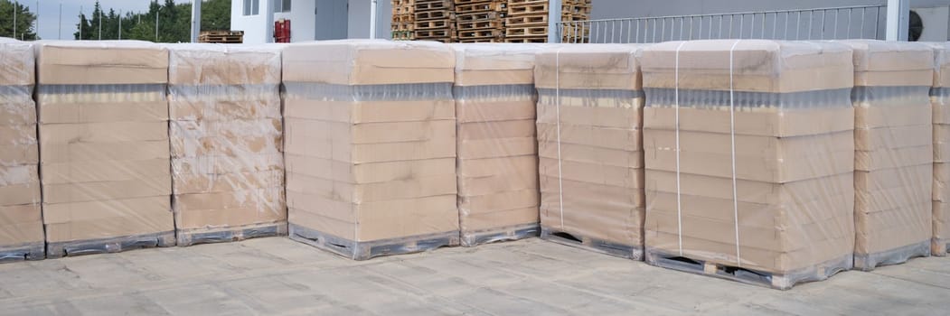 Rows of boxes and pallets in a warehouse and production warehouse. Warehouse storage of finished products concept