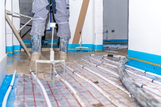 installation of liquid concrete on the floor for underfloor heating.