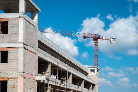 Construction crane working on large construction site