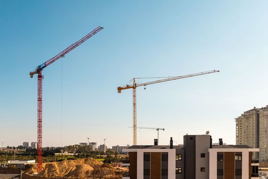 Construction crane working on large construction site