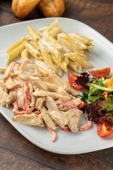 Grilled julienne cut chicken with pasta and salad