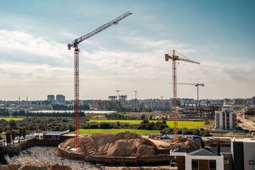 Construction crane working on large construction site