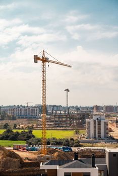 Construction crane working on large construction site