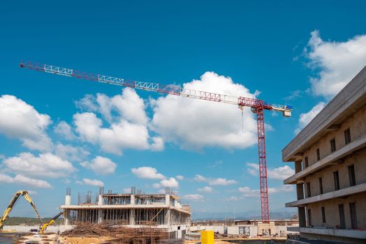 Construction crane working on large construction site