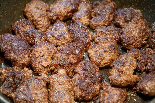 Grilled meatballs in a pan, traditional Turkish food concept. Selective focus