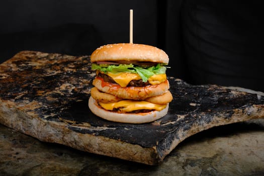 Rustic tasty Burger on Stone Background dark