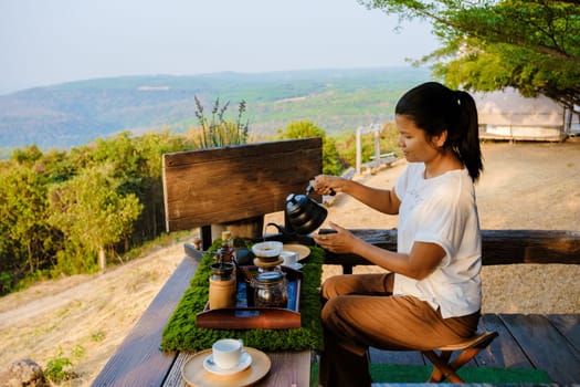 women making drip coffee in the mountains of Thailand. Asian woman preparing coffee on a tented camp