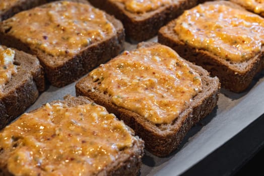 Slices of toasted bread covered with a mixture of egg and feta cheese