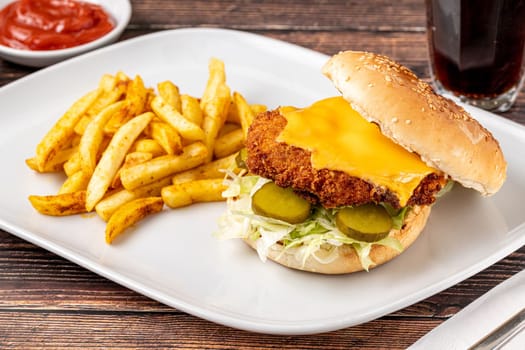 Chicken burger with french fries and ketchup on wooden table