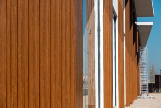The shopping mall with its facade covered with wood-patterned PVC panels