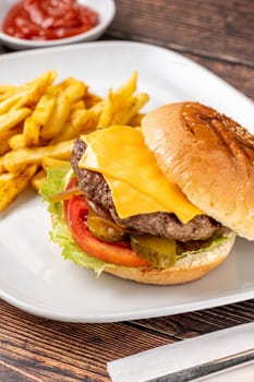 Cheeseburger with Tomatoes and Pickles with French Fries and Ketchup