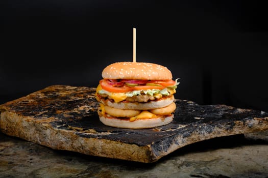 Rustic tasty Burger on Stone Background dark