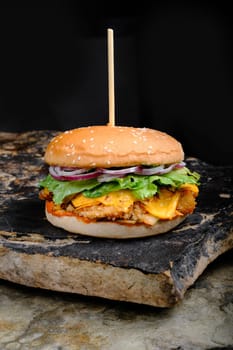 Rustic tasty Burger on Stone Background dark