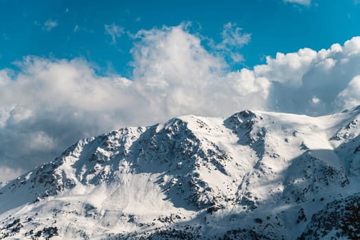 Forested snowy mountain landscape in the foothills on a sunny day