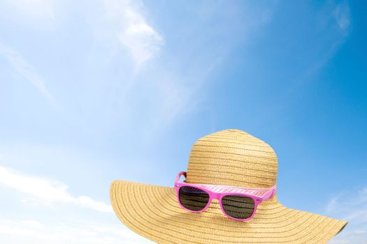 summer sunshine straw hat in blue sky on a sunny day. sunglasses summer concept with copy space blue background relaxation, Holiday,travel, beach,sun concept close up