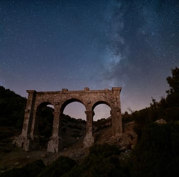 The ancient city of Ariassos, the city gate in a night when the Milky Way is visible