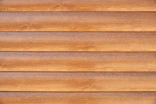 Facade cladding from solid wood handmade boards in brown color
