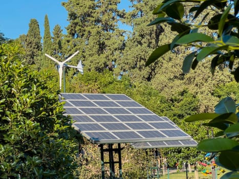 Wind turbine and solar panel installed in the green park area