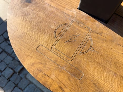 Public wireless smartphone station on wooden table