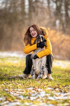 young teenage girl plays with her dog in nature. High quality photo