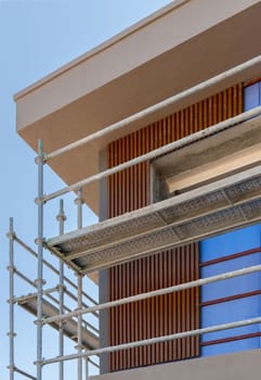 Construction scaffolding built on a new apartment building. new construction under construction