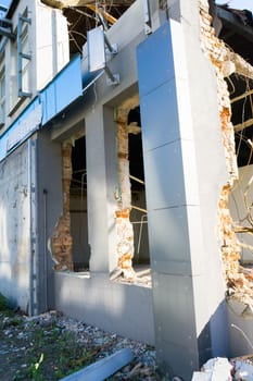 Background of process of demolition of a building. Excavator breaking old house.