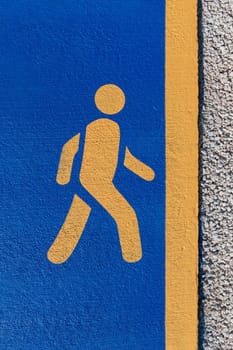 running sign, yellow running sign on a blue background on a jogging track