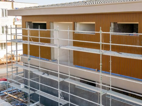 Construction scaffolding built on a new apartment building. new construction under construction