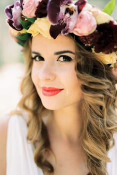 Bride in a wreath of bright flowers. Portrait. High quality photo