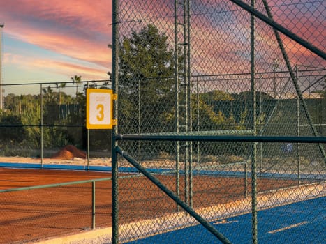 Sign showing tennis court number 3 on a sunny day