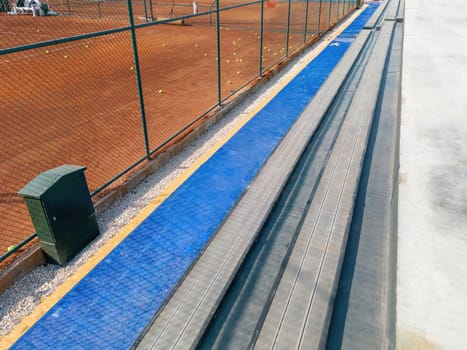 Seating area for spectators made with composite deck next to the tennis court