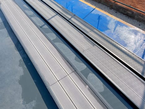 Seating area for spectators made with composite deck next to the tennis court