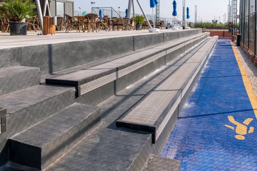 Seating area for spectators made with composite deck next to the tennis court