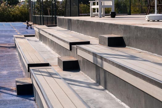 Seating area for spectators made with composite deck next to the tennis court