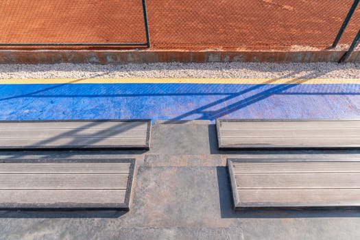 Seating area for spectators made with composite deck next to the tennis court