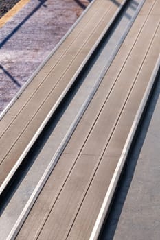 Seating area for spectators made with composite deck next to the tennis court