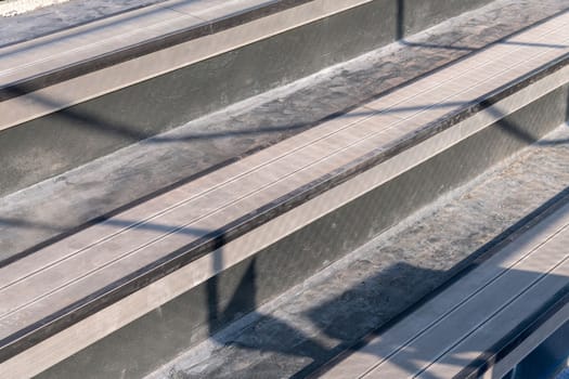 Seating area for spectators made with composite deck next to the tennis court