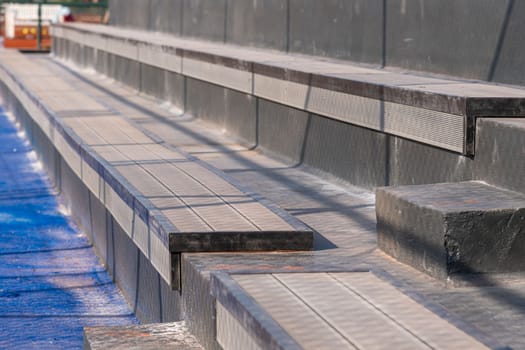 Seating area for spectators made with composite deck next to the tennis court