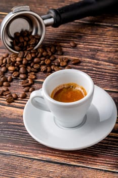 Fresh espresso coffee together decorated with coffee beans on wooden table