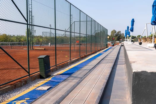 Seating area for spectators made with composite deck next to the tennis court