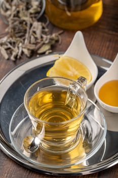 Freshly brewed hot winter tea on a wooden table