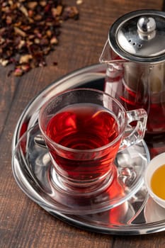 Freshly brewed hot winter tea on a wooden table