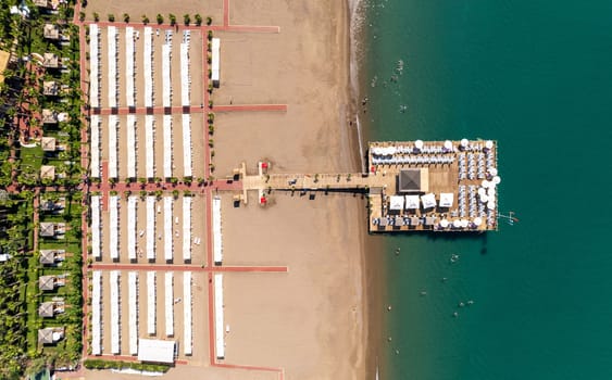 Aerial drone photo of hotel beach and pier on a sunny day