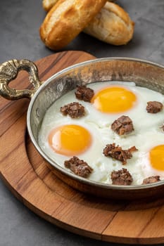 Turkish scrambled eggs Turkish name Kavurmali Yumurta with roasted meat in copper pan