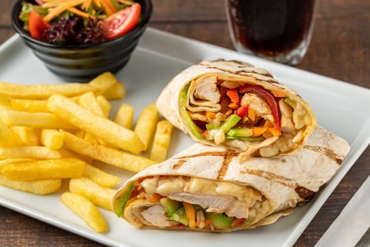 Chicken veggie wrap with french fries and salad