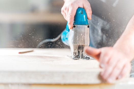 wood carving by hand with an electric saw. 
